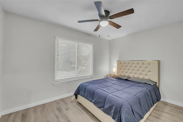 a view of a livingroom with a ceiling fan and window