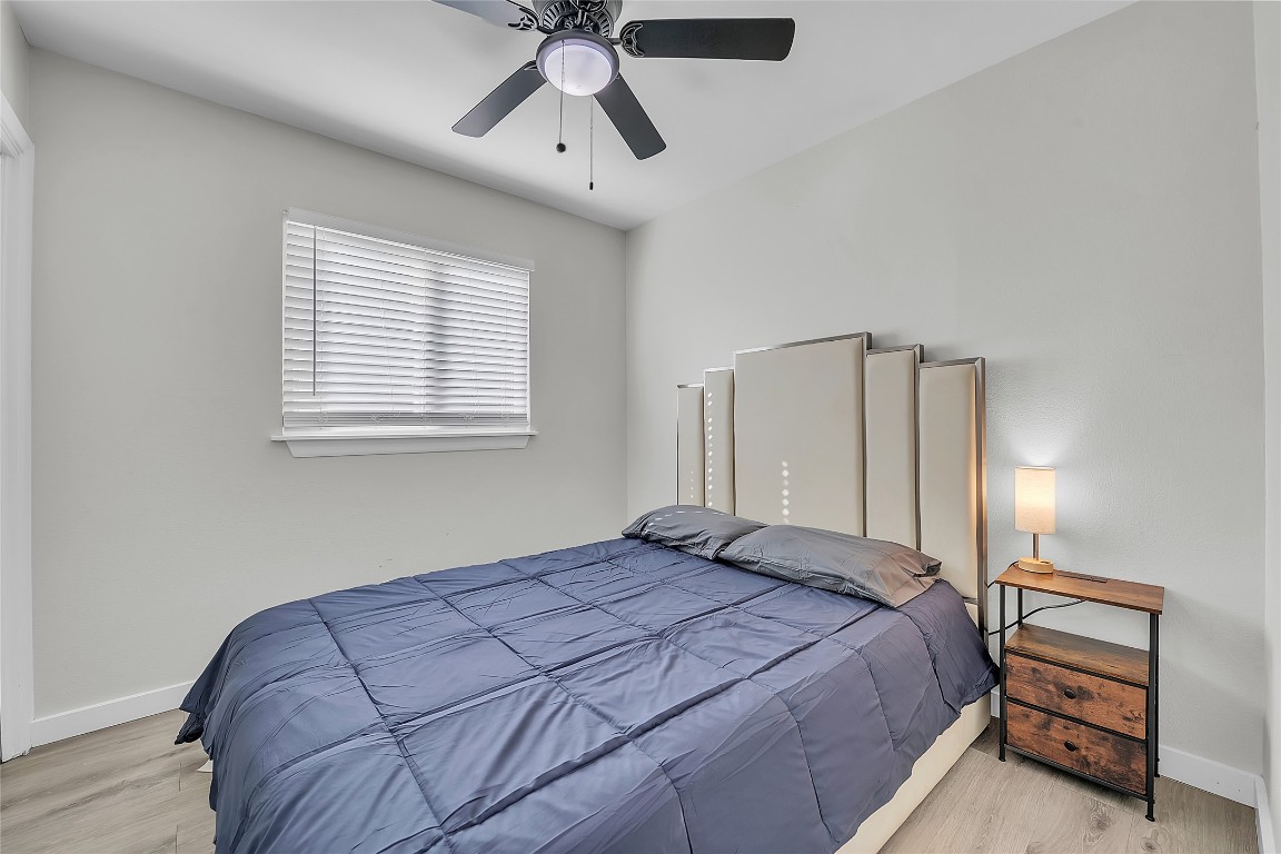 3400 Laguna Drive Austin, TX 78741 - Photo 20 of 24 a bedroom with a bed and a chandelier