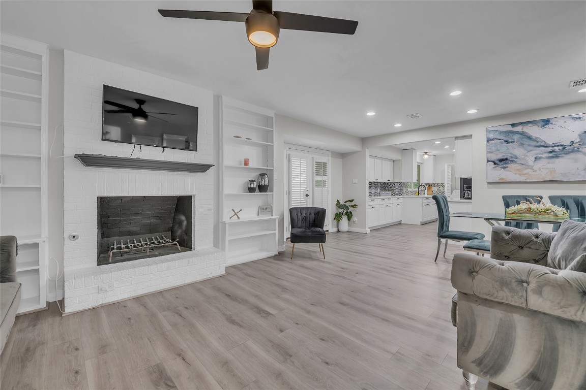 3400 Laguna Drive Austin, TX 78741 - Photo 4 of 24 a living room with furniture a fireplace and a flat screen tv