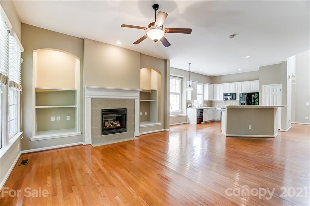 142 Blandina Court Fort Mill, SC 29708 - Photo 13 of 40 a view of a livingroom with a fireplace a ceiling fan and windows