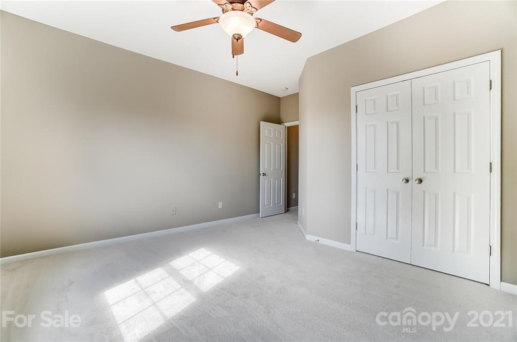 142 Blandina Court Fort Mill, SC 29708 - Photo 38 of 40 an empty room with a chandelier fan and windows