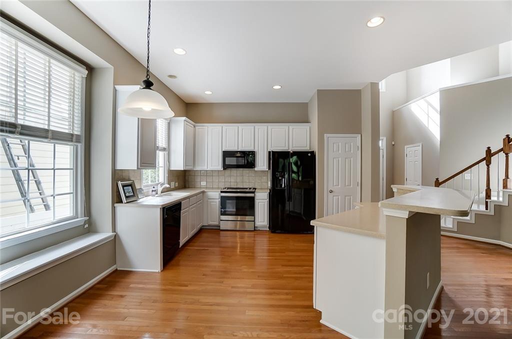 142 Blandina Court Fort Mill, SC 29708 - Photo 6 of 40 a large kitchen with stainless steel appliances refrigerator a stove top oven and cabinets