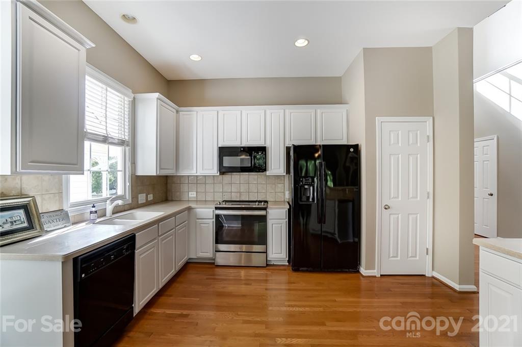 142 Blandina Court Fort Mill, SC 29708 - Photo 7 of 40 a kitchen with stainless steel appliances granite countertop a refrigerator and a stove top oven