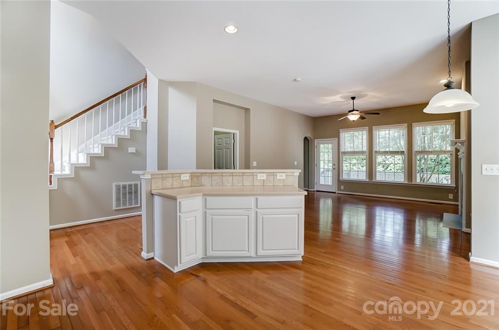 142 Blandina Court Fort Mill, SC 29708 - Photo 9 of 40 a view of a large kitchen with wooden floor and a window