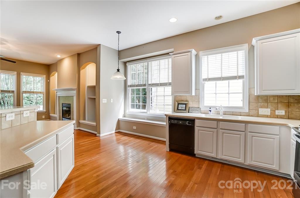 142 Blandina Court Fort Mill, SC 29708 - Photo 10 of 40 a large kitchen with kitchen island granite countertop a stove a sink and a large window