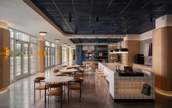 a dining room with furniture and a floor to ceiling window