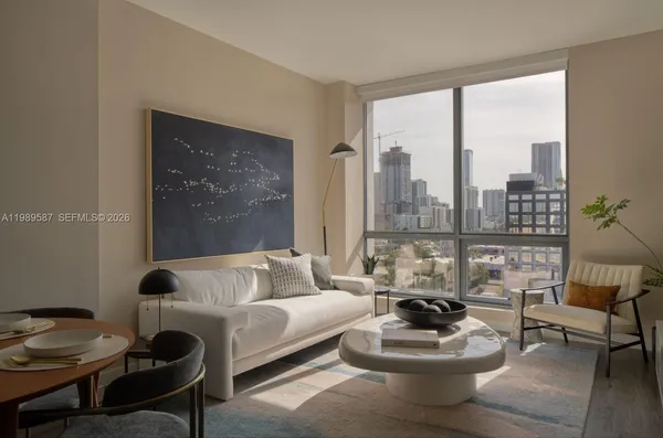 a living room with furniture and a large window