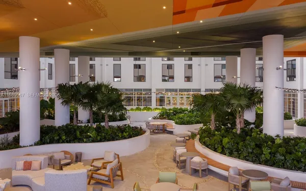 a view of an house with backyard and sitting area