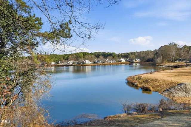 a view of staircase with lots of frames on wall and a wooden floor