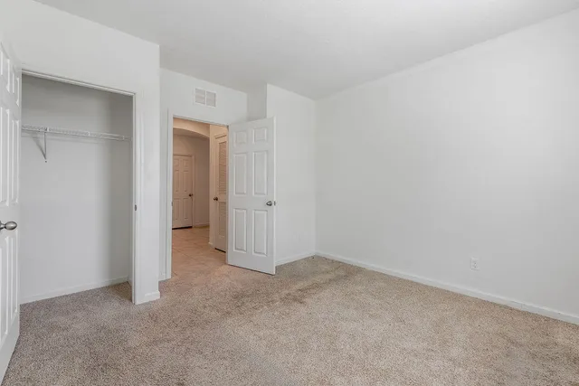 a large kitchen with stainless steel appliances kitchen island granite countertop a refrigerator and a stove top oven