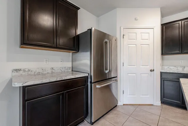 a kitchen with stainless steel appliances granite countertop a stove microwave and refrigerator