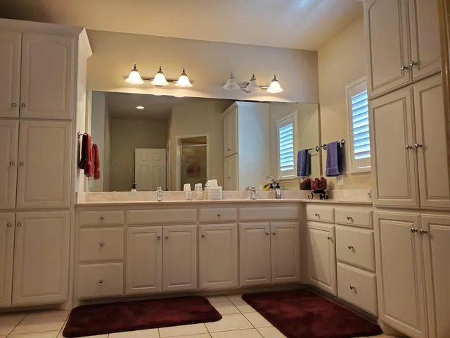 a spacious bathroom with a sink and a mirror