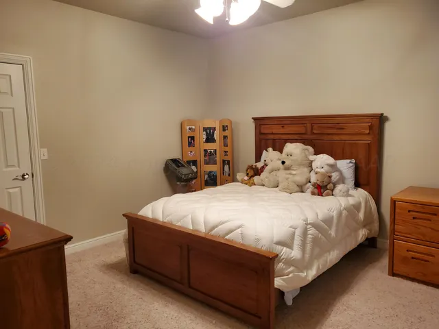 a large bed sitting in a bedroom next to a window