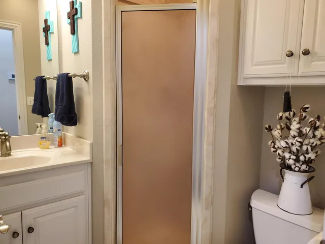 a bathroom with a sink toilet and mirror