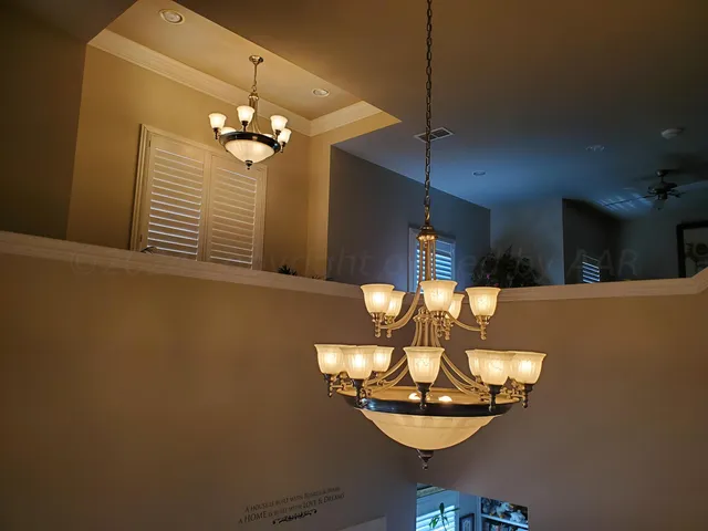 a view of a dining room with a table and chandelier