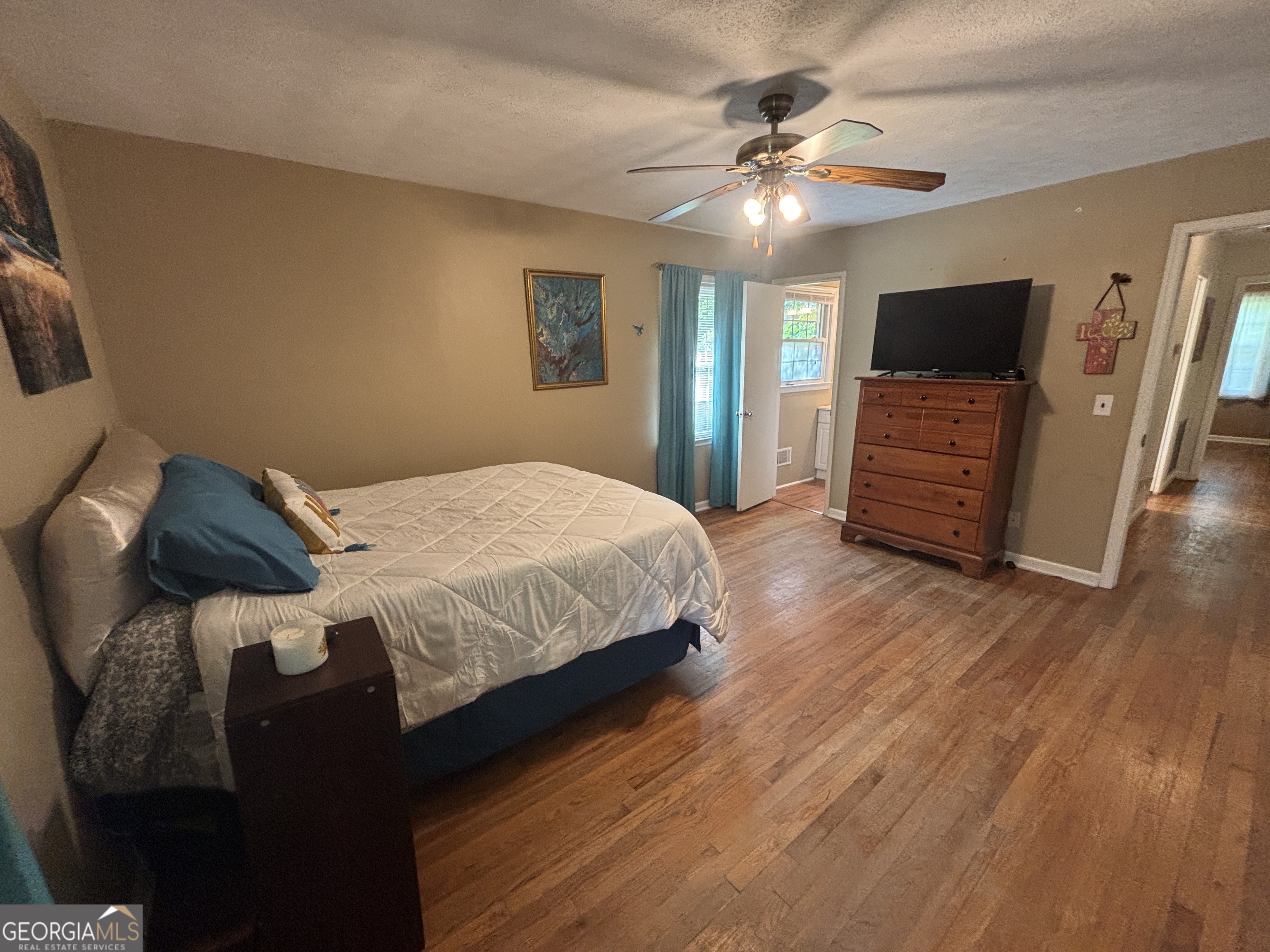 152 Crest Drive Cochran, GA 31014 - Photo 21 of 54 a bedroom with a bed and a flat screen tv