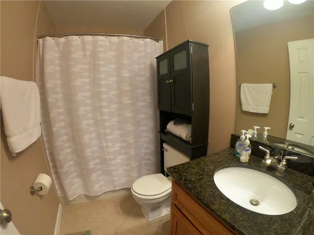 a bathroom with a sink toilet and mirror