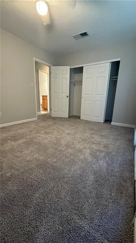 en empty room with windows and closet