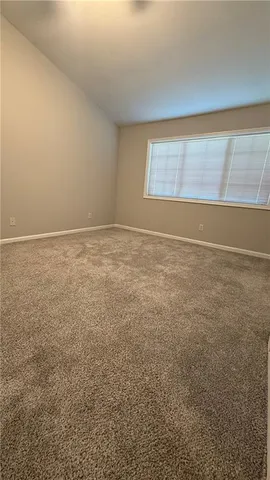a bathroom with a granite countertop toilet sink and mirror