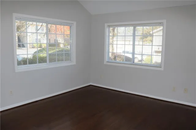 a front view of a house with a yard and potted plants