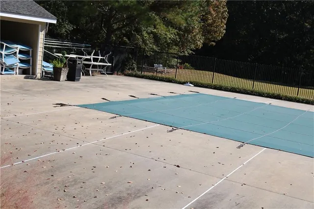 a view of a house with wooden deck next to a yard