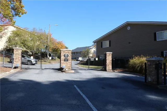 a view of a city street with a car parked on the road