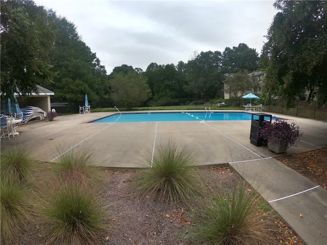 a view of a swimming pool with a yard