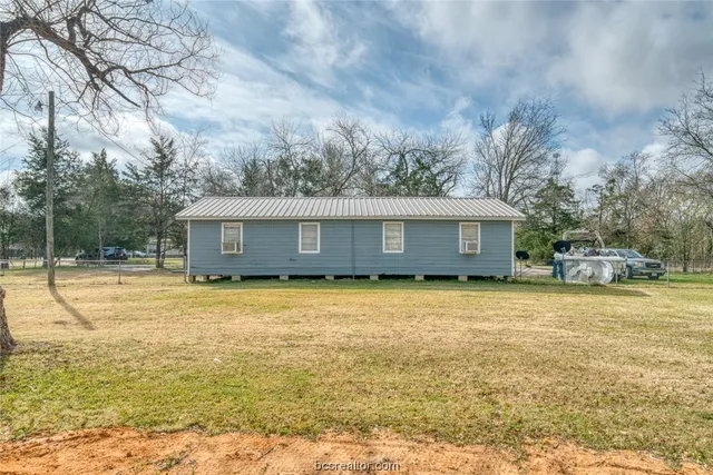 a view of a house with snow on the yard