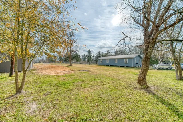 a view of backyard of house with outdoor seating