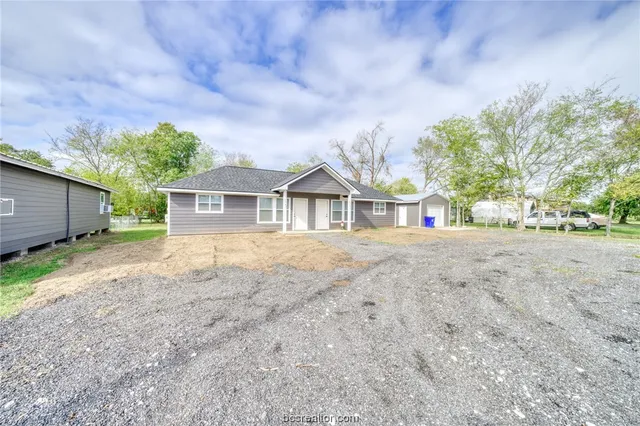 a house with lots of trees in the background