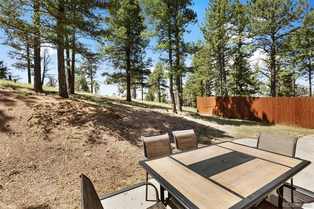 a view of a backyard with sitting area