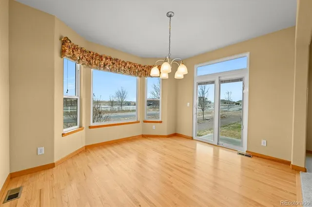 a view of an empty room with glass door and a window