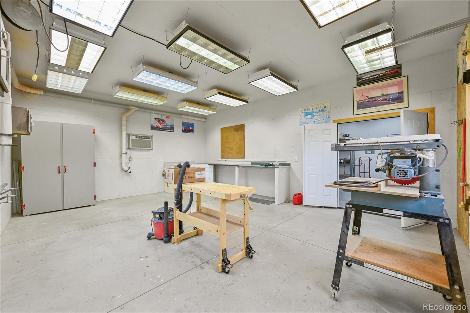 16231 Rayburn Street Hudson, CO 80642 - Photo 28 of 50 a living room with furniture and a gym machine
