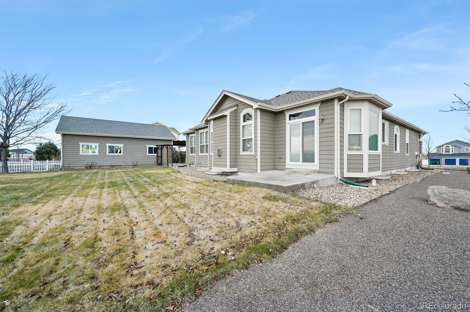 16231 Rayburn Street Hudson, CO 80642 - Photo 42 of 50 a front view of a house with a garden