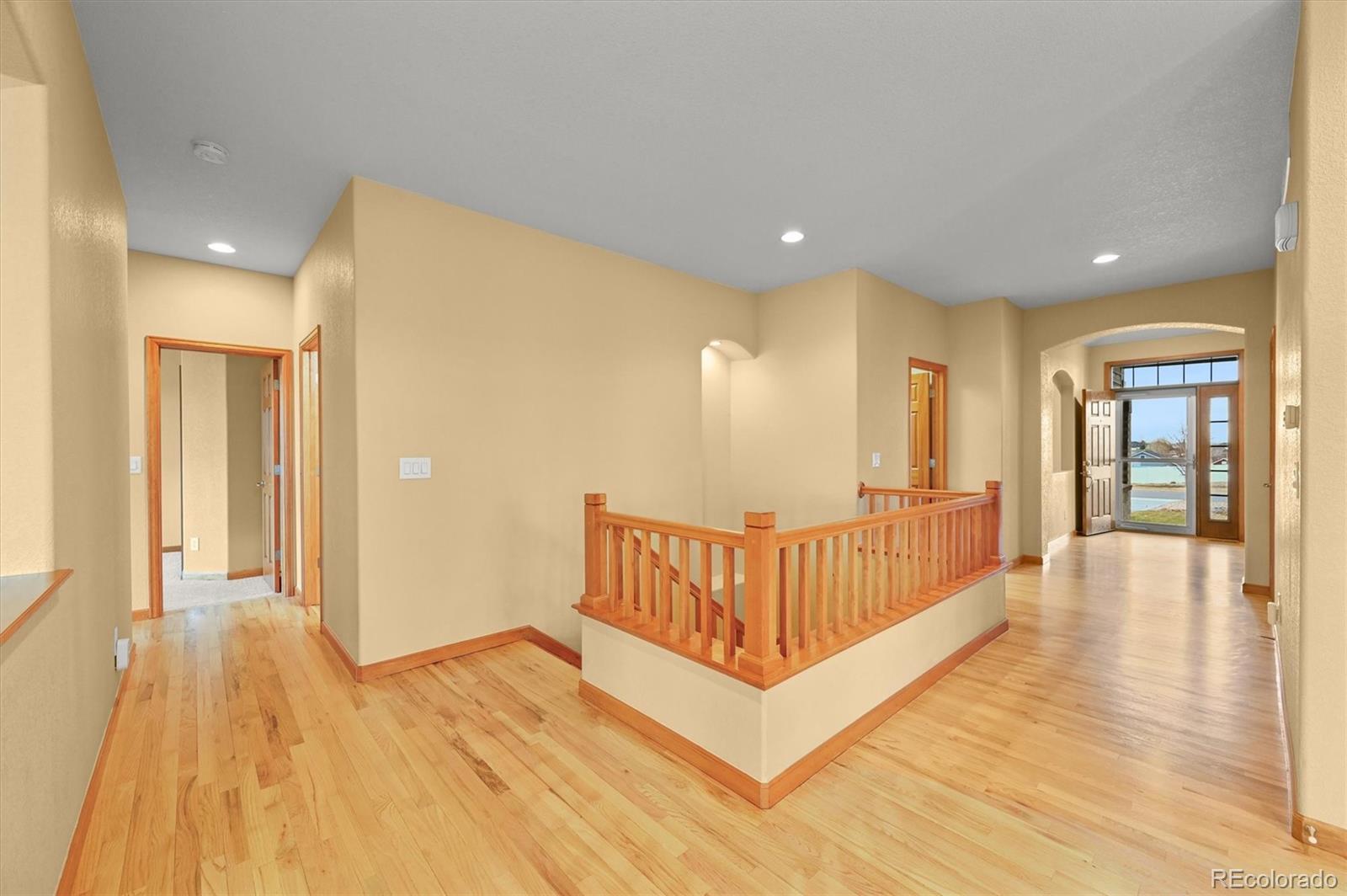 16231 Rayburn Street Hudson, CO 80642 - Photo 9 of 50 a view of a hallway with wooden floor and windows