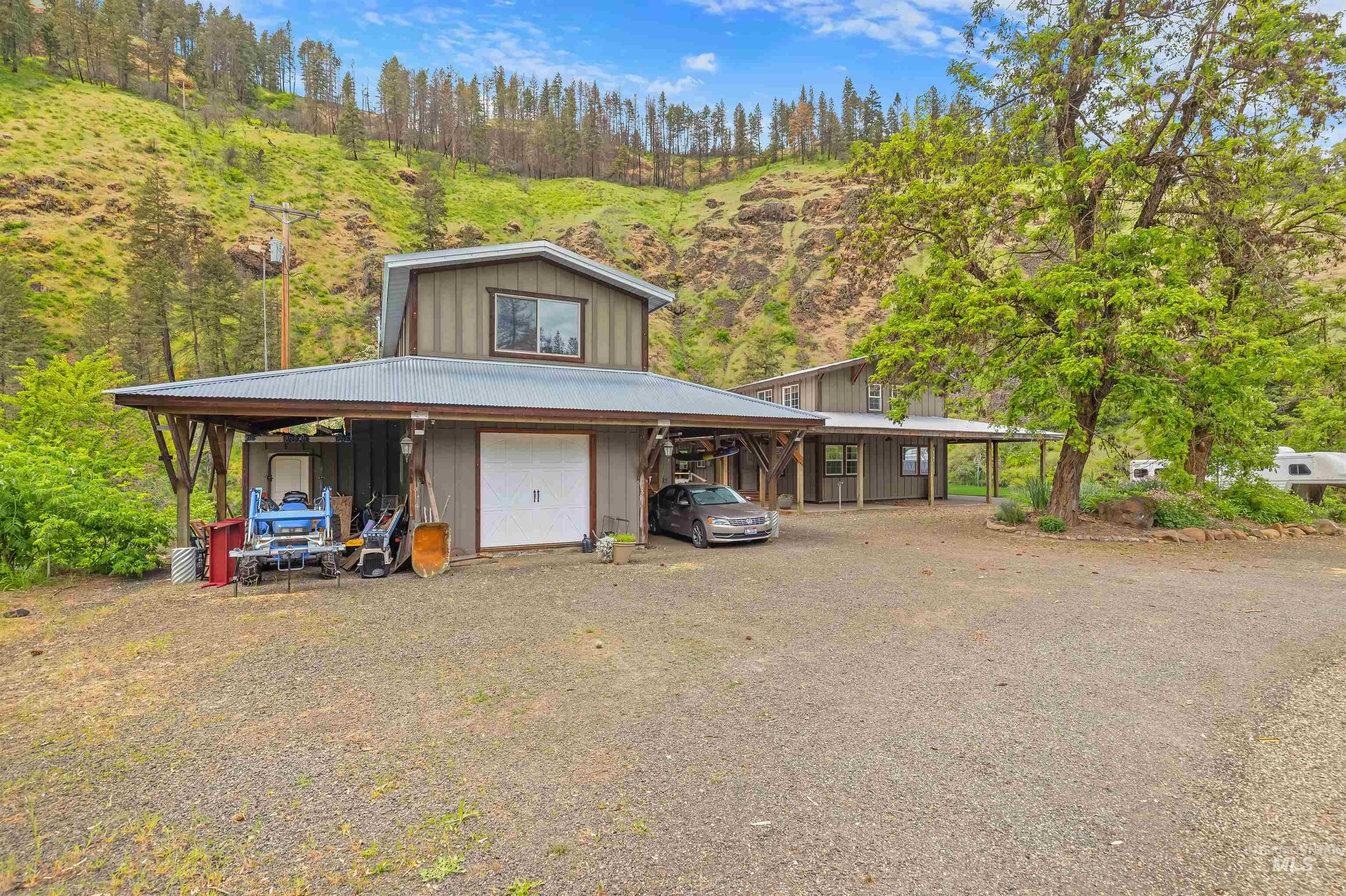 1314 Cedar Ridge Road Kendrick, ID 83537 - Photo 4 of 50 Property featuring a metal roof, an attached covered carport, and a gravel driveway