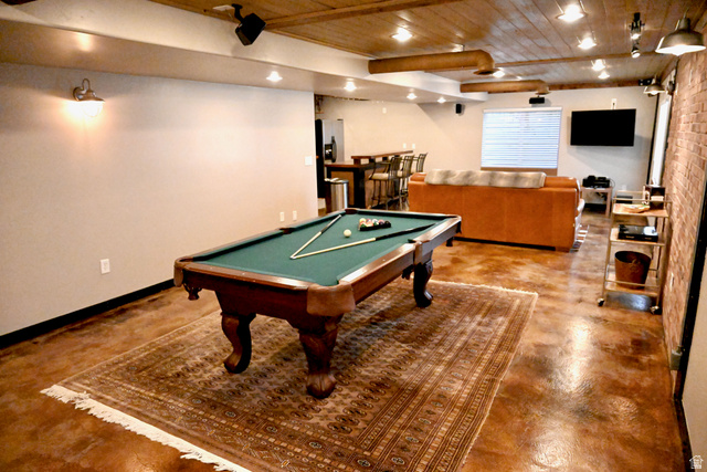 314 Brown Farm Lane Draper, UT 84020 - Photo 27 of 57 Spacious entertainment area featuring wood-finish flooring, a beamed wood ceiling, and exposed brick accents