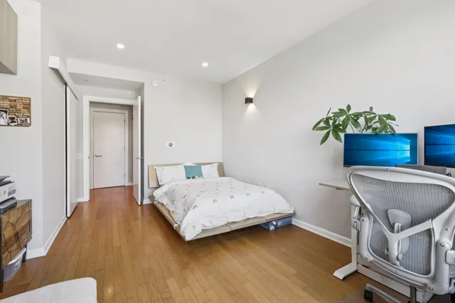 a bedroom with a bed and a chair