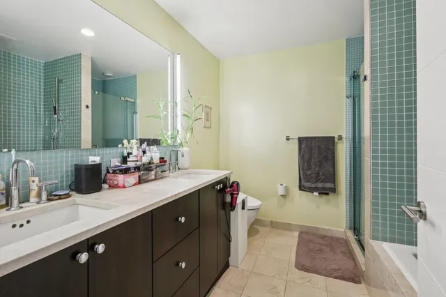 a bathroom with a sink double vanity and a mirror