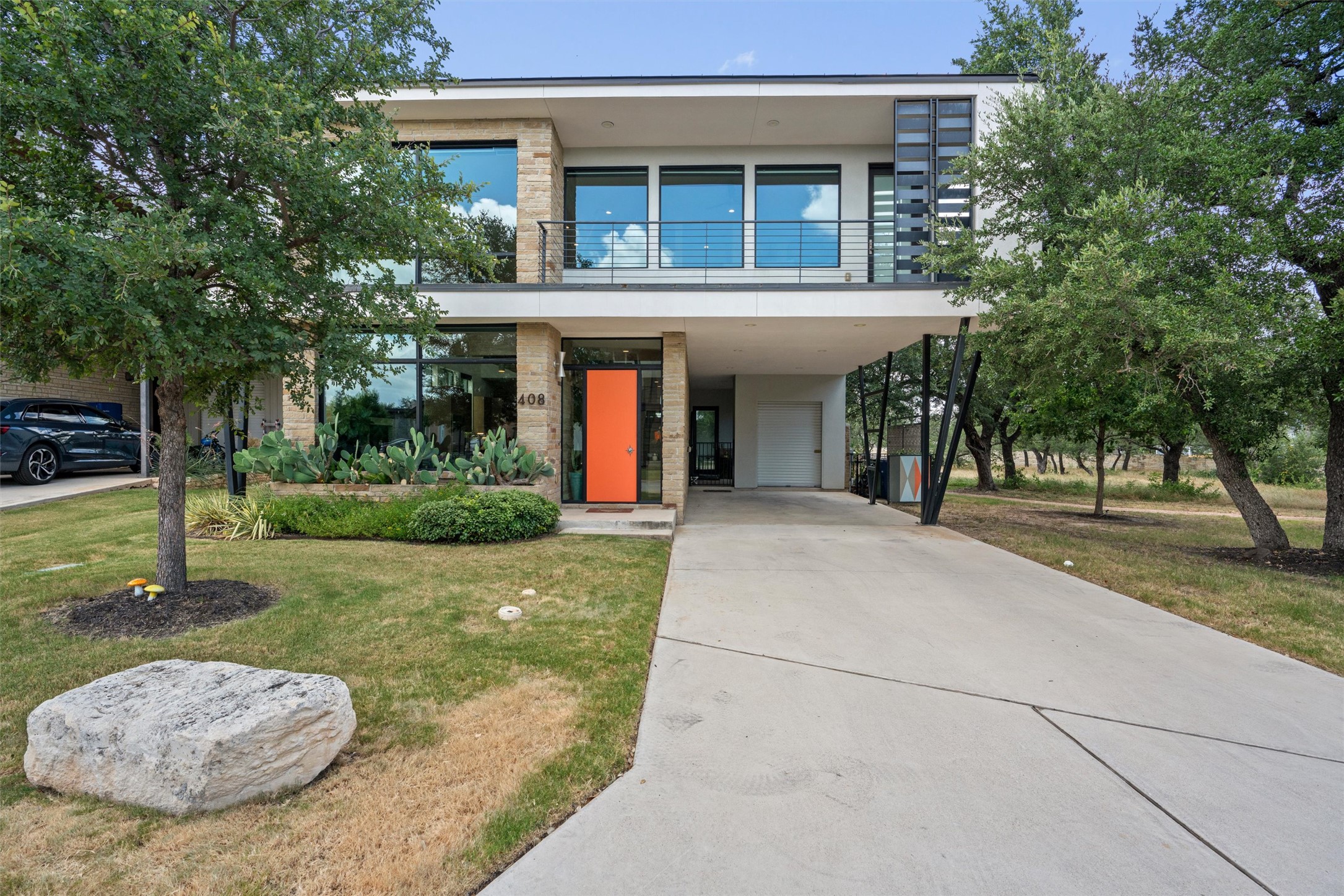 408 Starlight Village Loop Leander, TX 78641 - Photo 2 of 40 Modern architecture with a vibrant front door and well-manicured landscaping beckons you home.