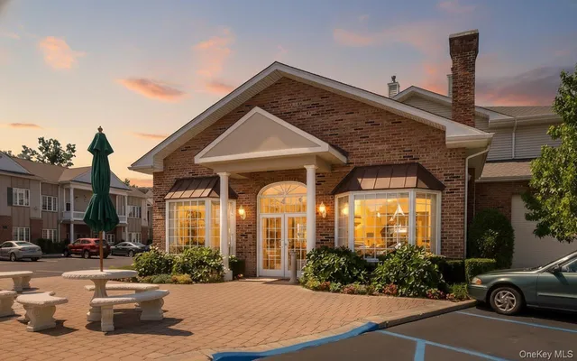 a view of a house with a patio and a yard
