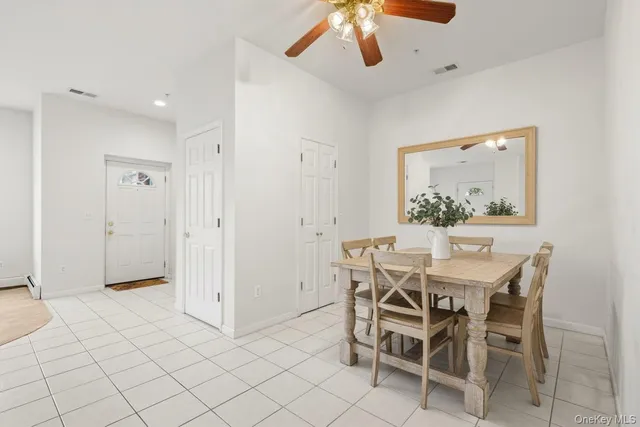 an empty room with chandelier fan