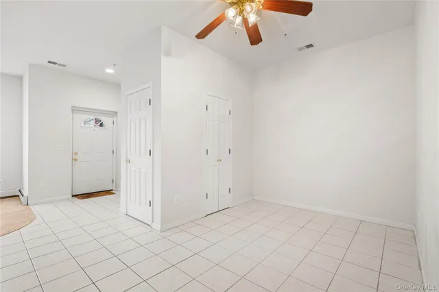 a living room with furniture a flat screen tv and a large window