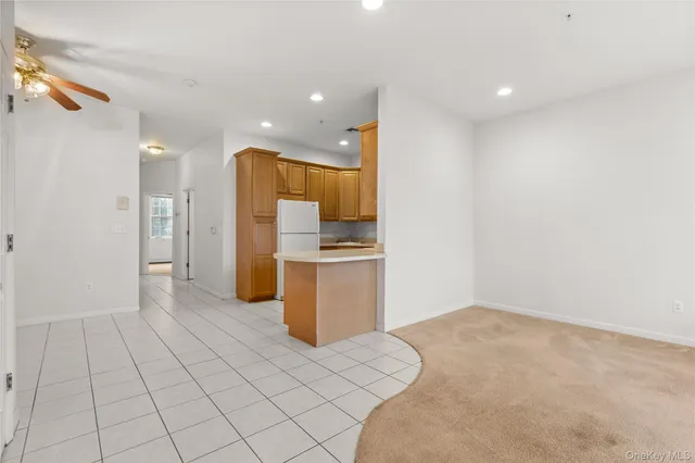 a kitchen with cabinets and refrigerator