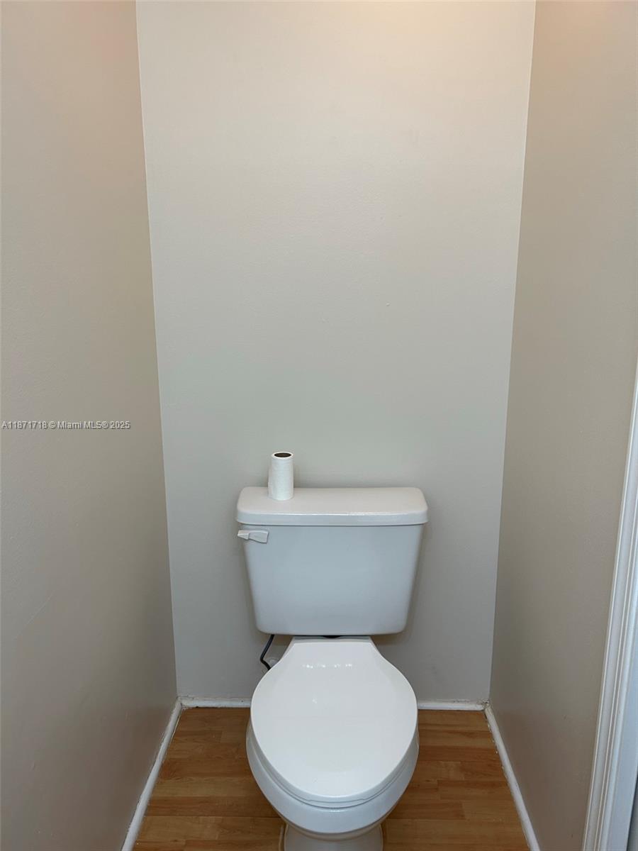 15851 Southwest 10th Street, Unit 15851 Pembroke Pines, FL 33027 - Photo 8 of 17 a white toilet sitting next to a white wall