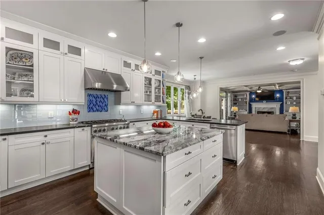 a kitchen with stainless steel appliances granite countertop a stove and a sink