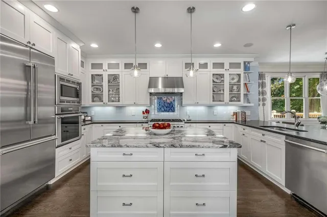 a kitchen with counter top space cabinets and stainless steel appliances