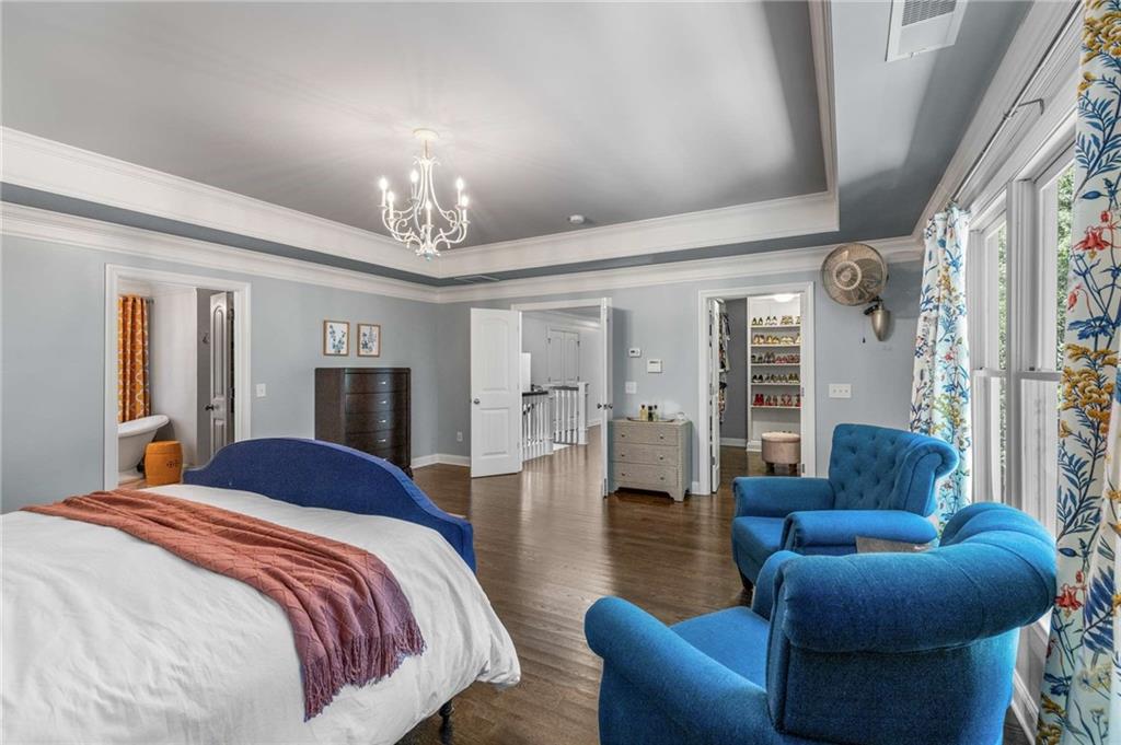 2456 Sunset Drive Northeast Atlanta, GA 30345 - Photo 25 of 49 a bed room with furniture and a chandelier