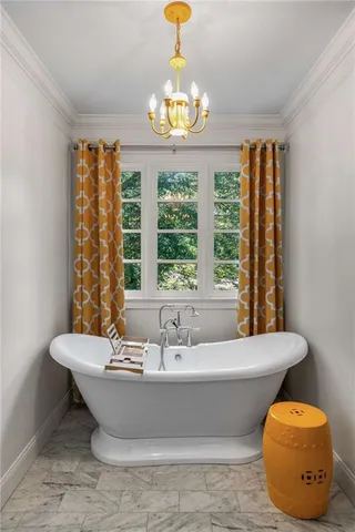 a bathroom with a tub and a large window