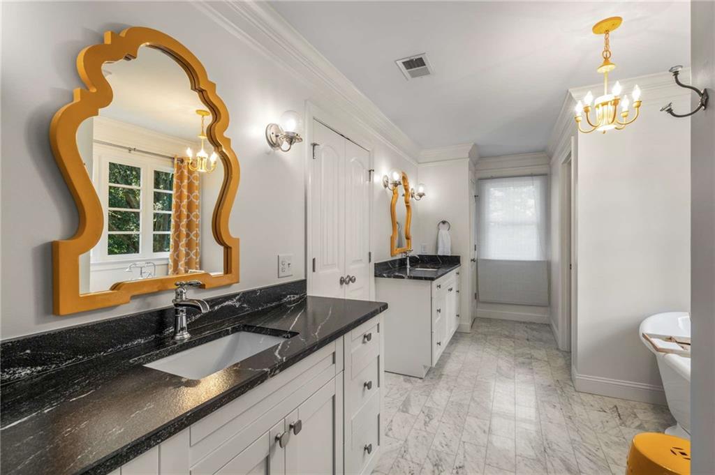 2456 Sunset Drive Northeast Atlanta, GA 30345 - Photo 30 of 49 a bathroom with a sink and a mirror